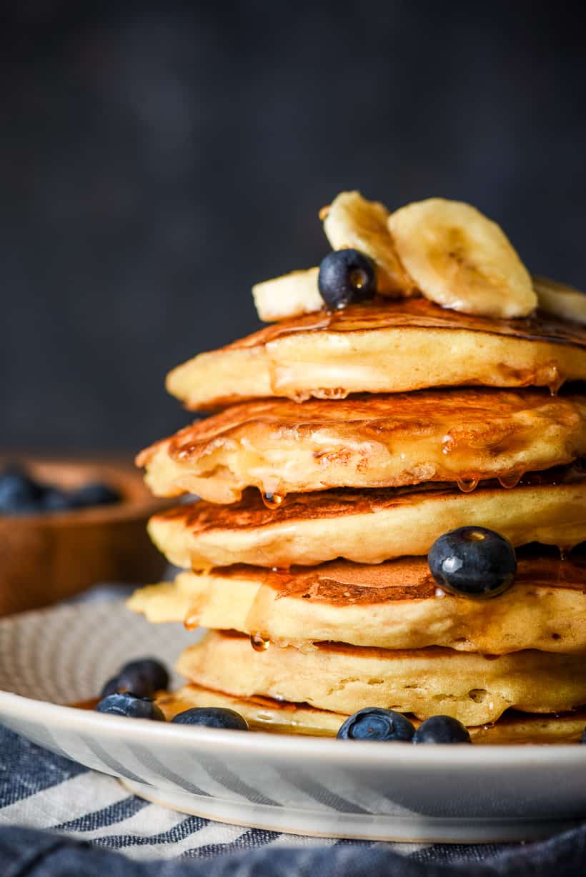 a stack of pancakes with blueberries and bananas on top