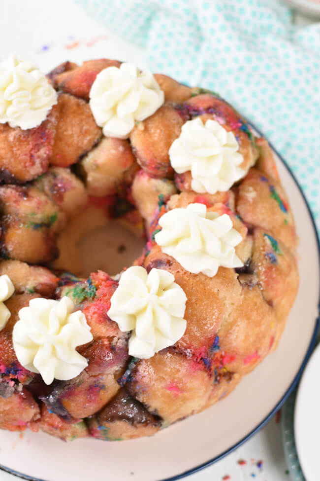 Top view of monkey bread baked in a bundt pan, piped with icing