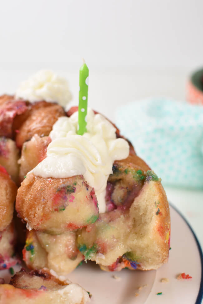 monkey bread baked with icing and a green candle