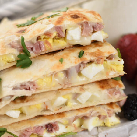 a stack of golden brown quesadillas with melted cheese