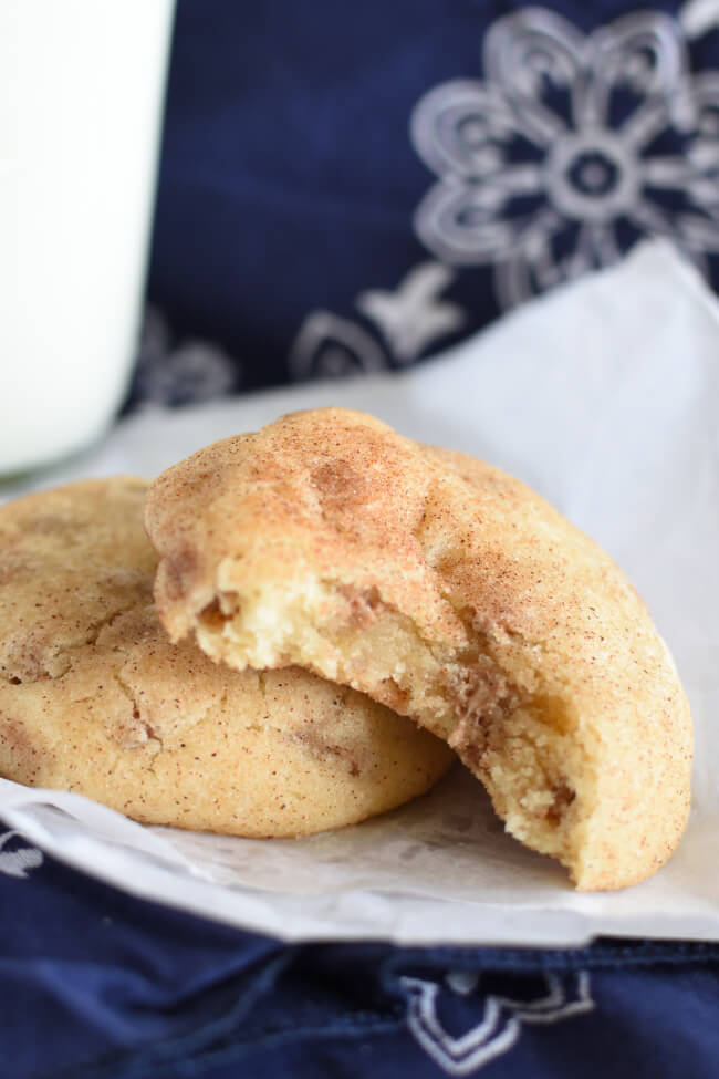 two baked snickerdoodle cookies on a white paper