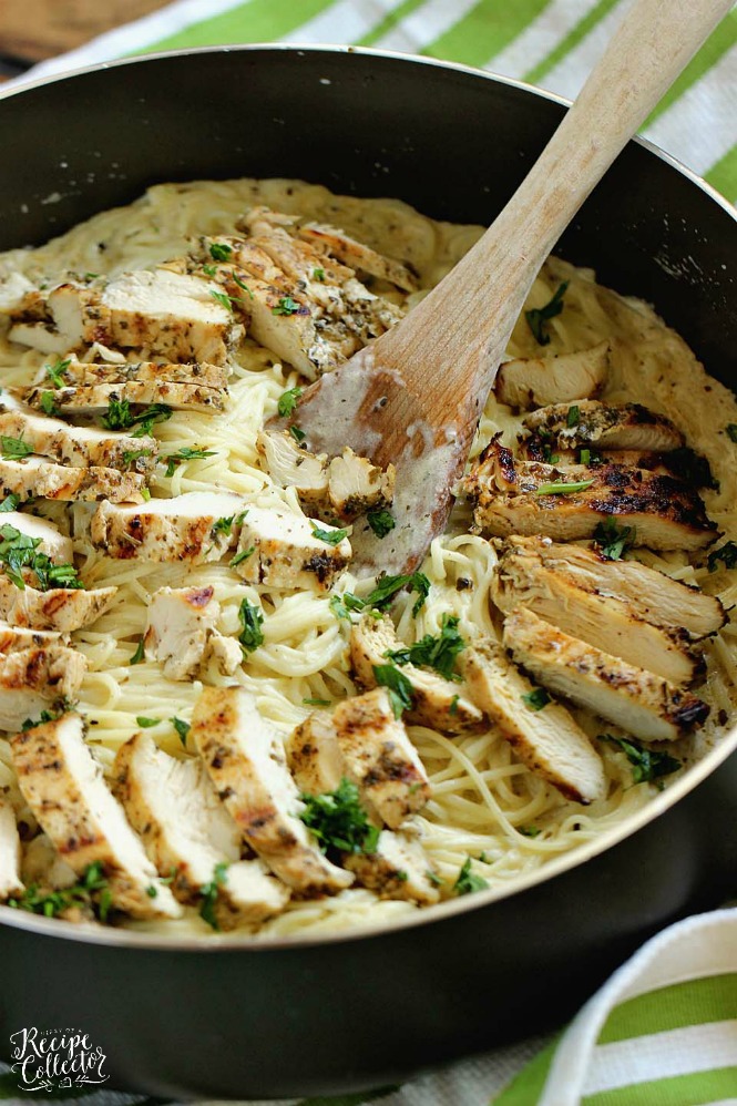 a skillet with angel hair pasta topped with sliced chicken