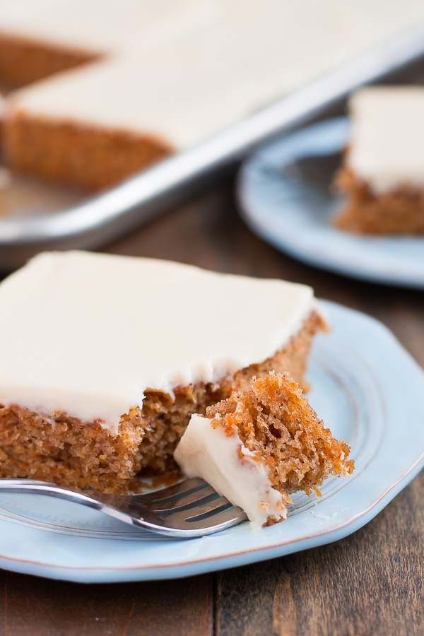 A plate with a square of carrot cake with white icing