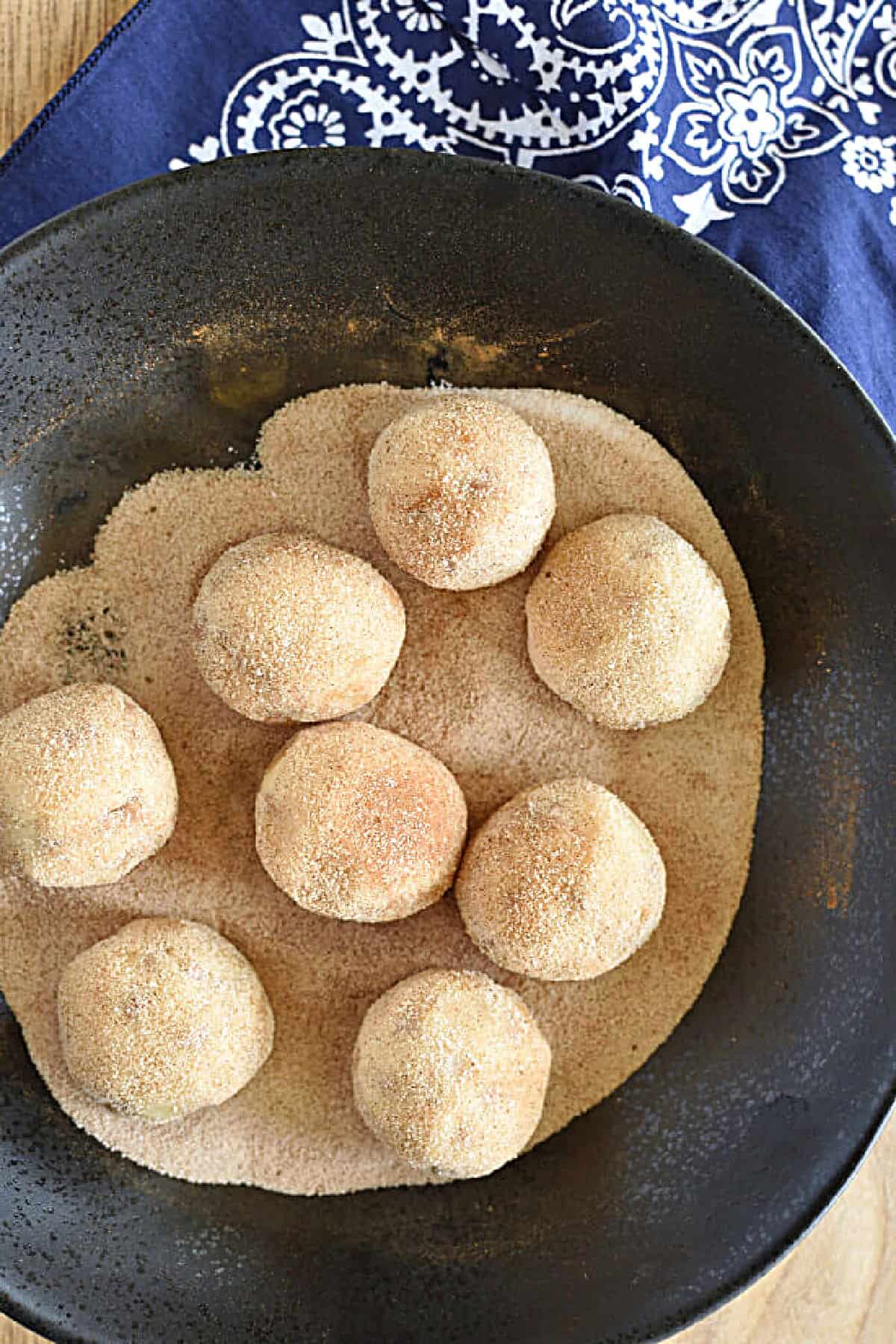 Cookie dough balls rolled in cinnamon and sugar.