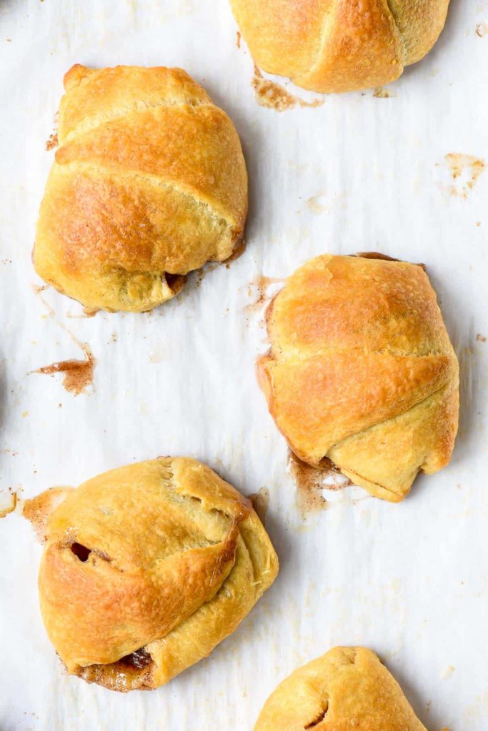 a cookie sheet with golden brown baked rolls