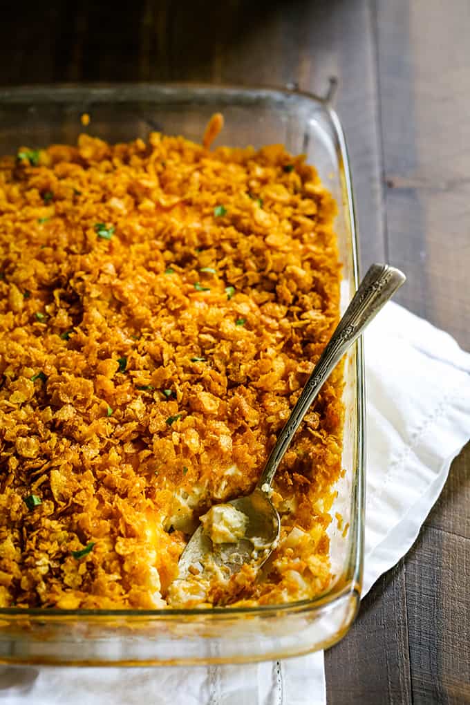 a baking dish with cheesy hasbrowns topped with golden brown cornflakes crumbs