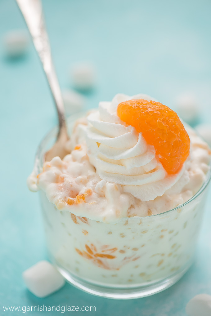 a glass dish with creamy pasta salad with mandarin oranges, whipped cream on top