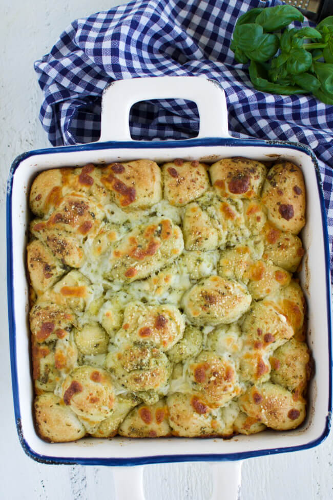 a baking dish with golden brown and cheesy monkey bread
