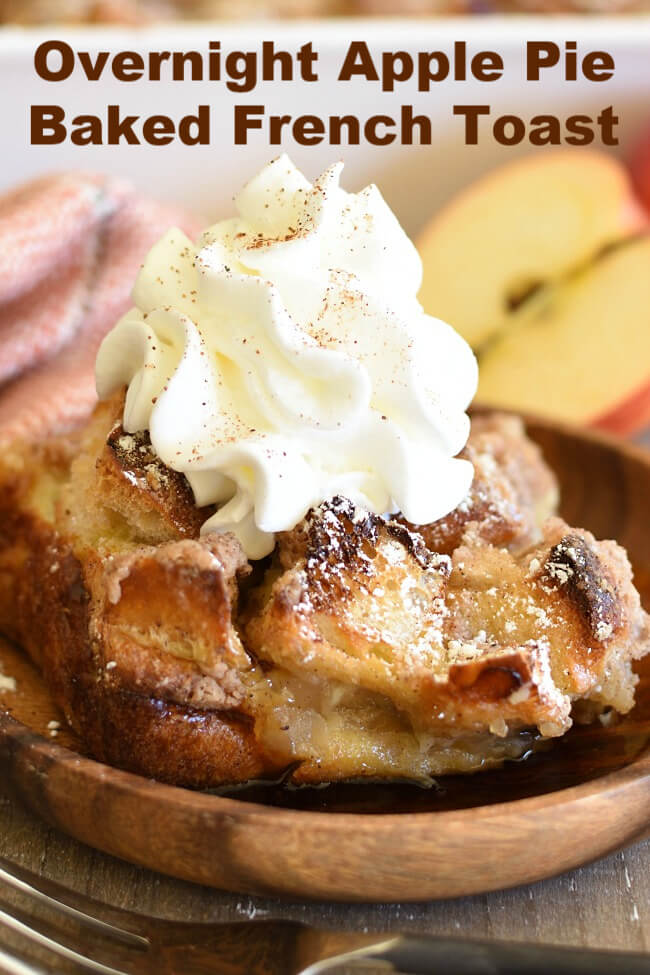 a dish with French Toast casserole dusted with powdered sugar and topped with whipped cream