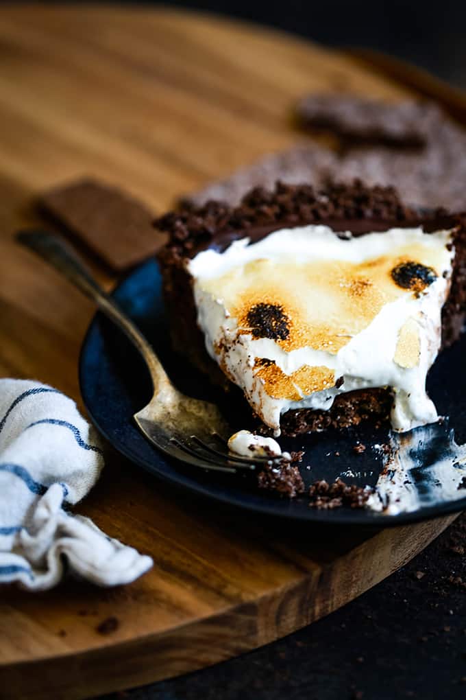 a plate with chocolate pie topped with golden brown toasted marshmallows