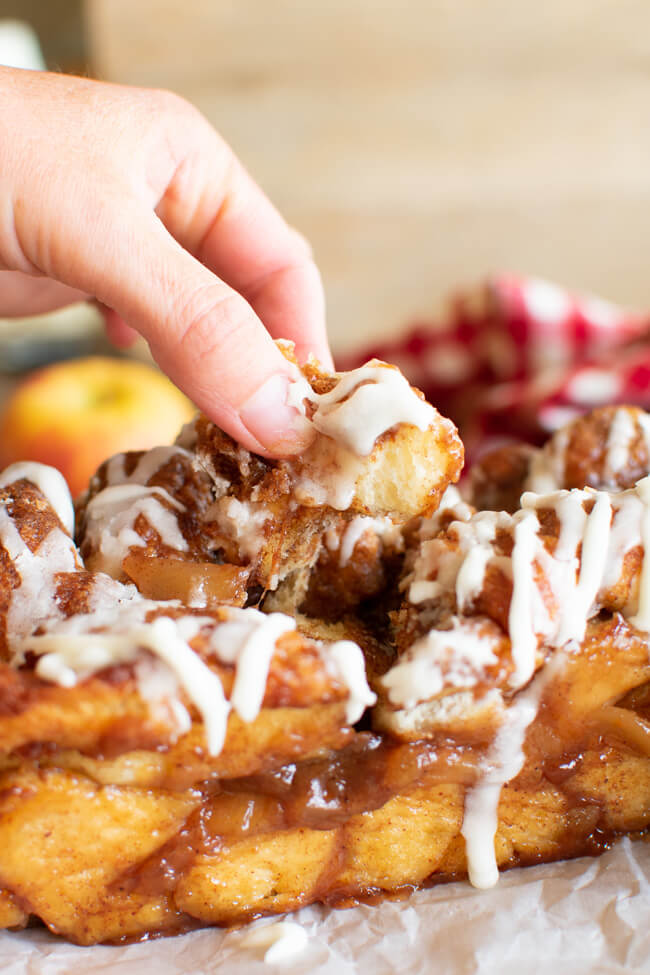 loaf of pull apart bread with a finger pulling a piece out