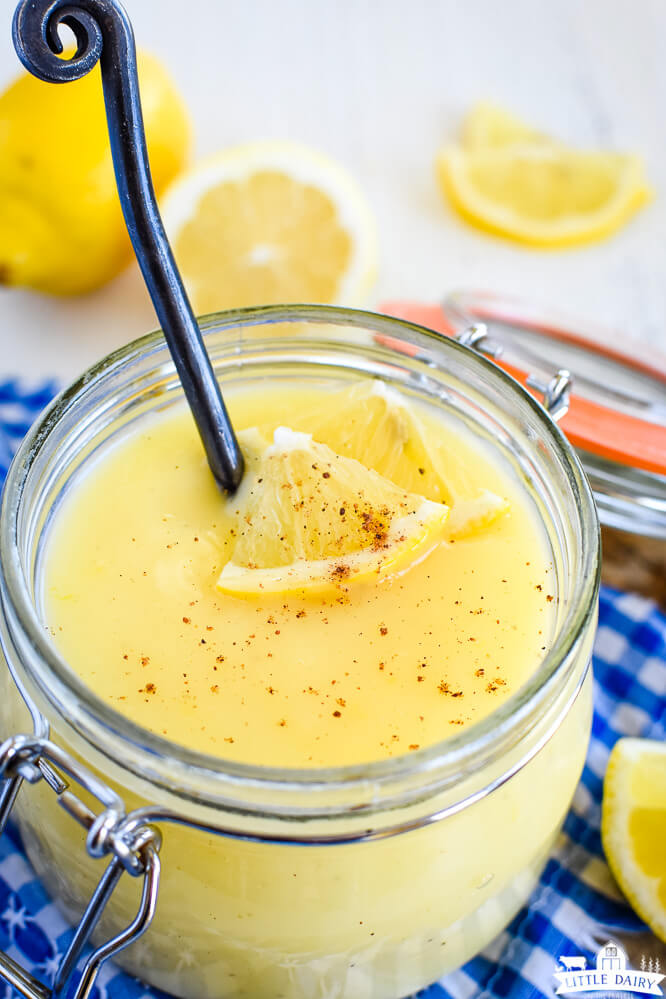 lemon sauce with fresh lemons and nutmeg in a glass jar