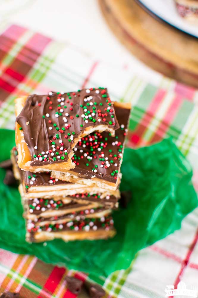 a stack of soda cracker candy on a green tissue paper and a plaid napkin.