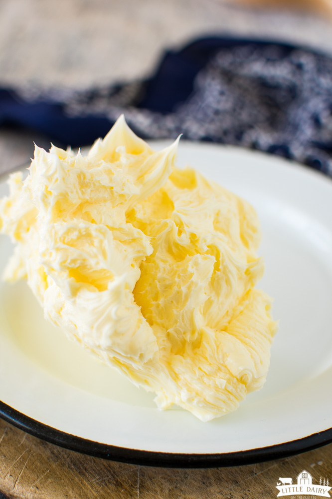 a white plate with a pile of whipped butter