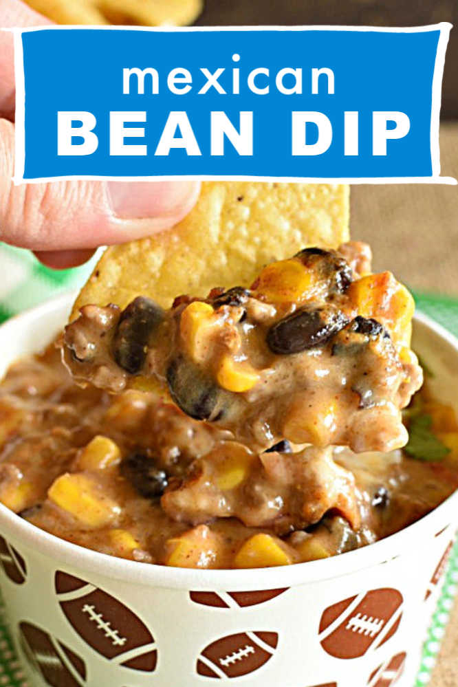 a paper cup with dip made with beans, corn, and ground beef with chips and a text overlay