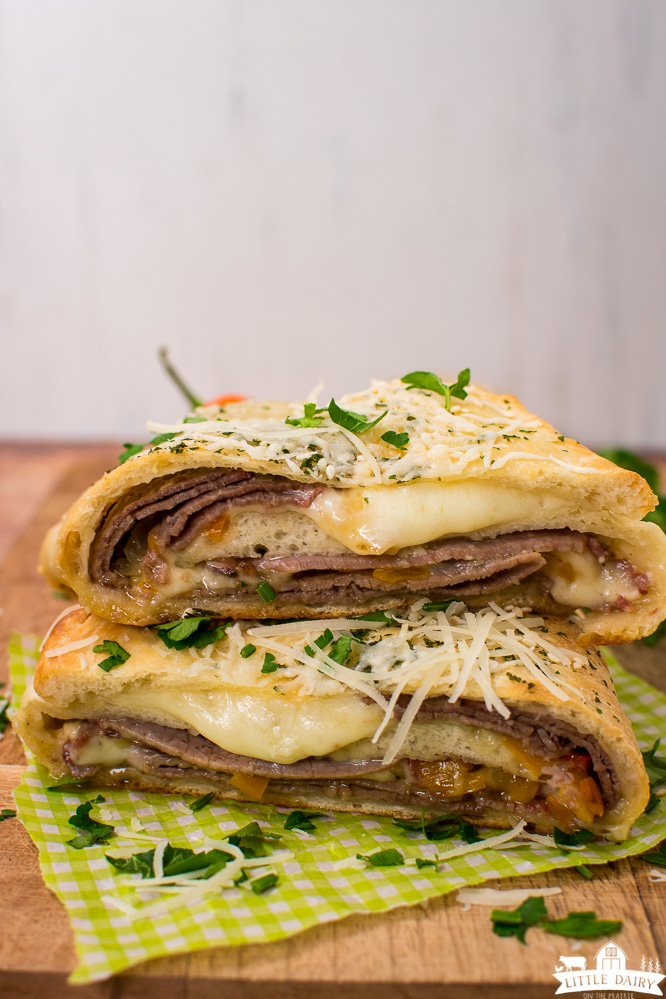two slices of beef and cheese calzone stacked on top of each other