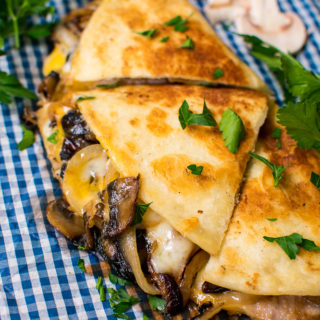 Three wedges of tortillas filled with mushrooms and onions.