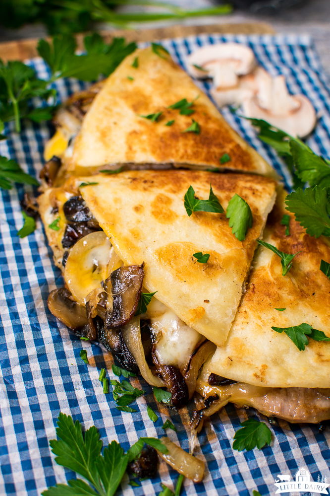 pork and mushroom quesadillas that are golden brown and sprinkled with parsley