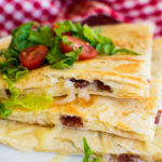 Golden brown quesadillas made with bacon and white cheese.