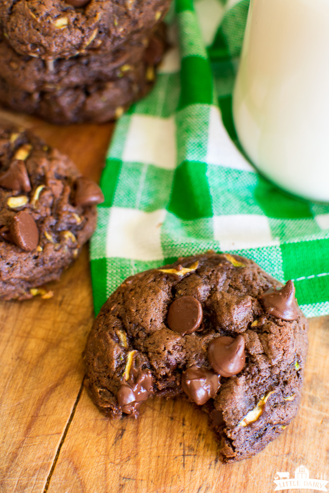 Chocolate cookies with chocolate chips and zucchini with a bite taken out of it
