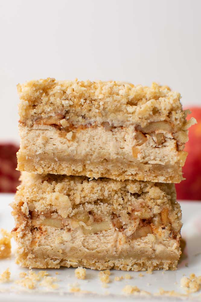 two apple cheesecake bars stacked on top of each other