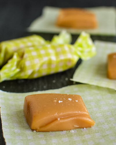 A caramel square with sea salt in a candy wrapper.