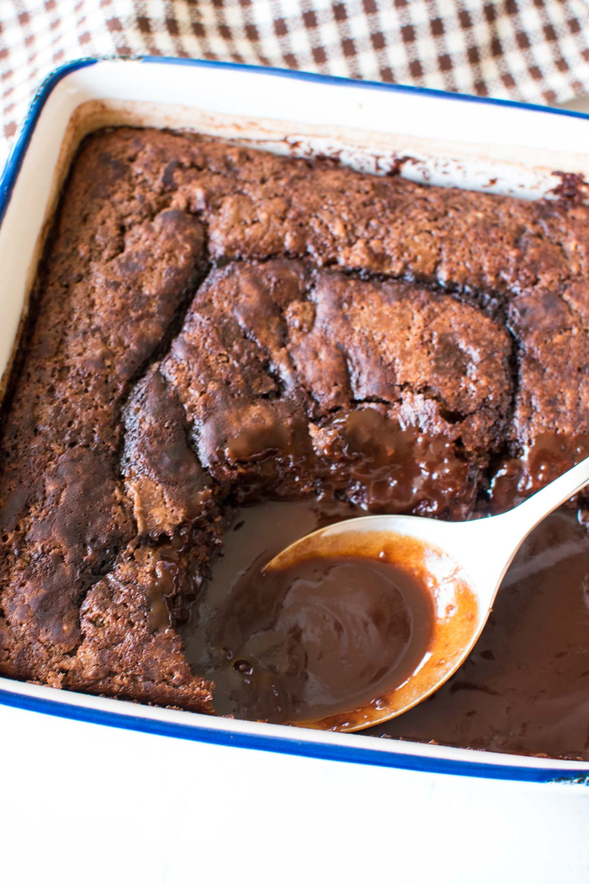 A baking dish with chocolate cake and hot fudge sauce.