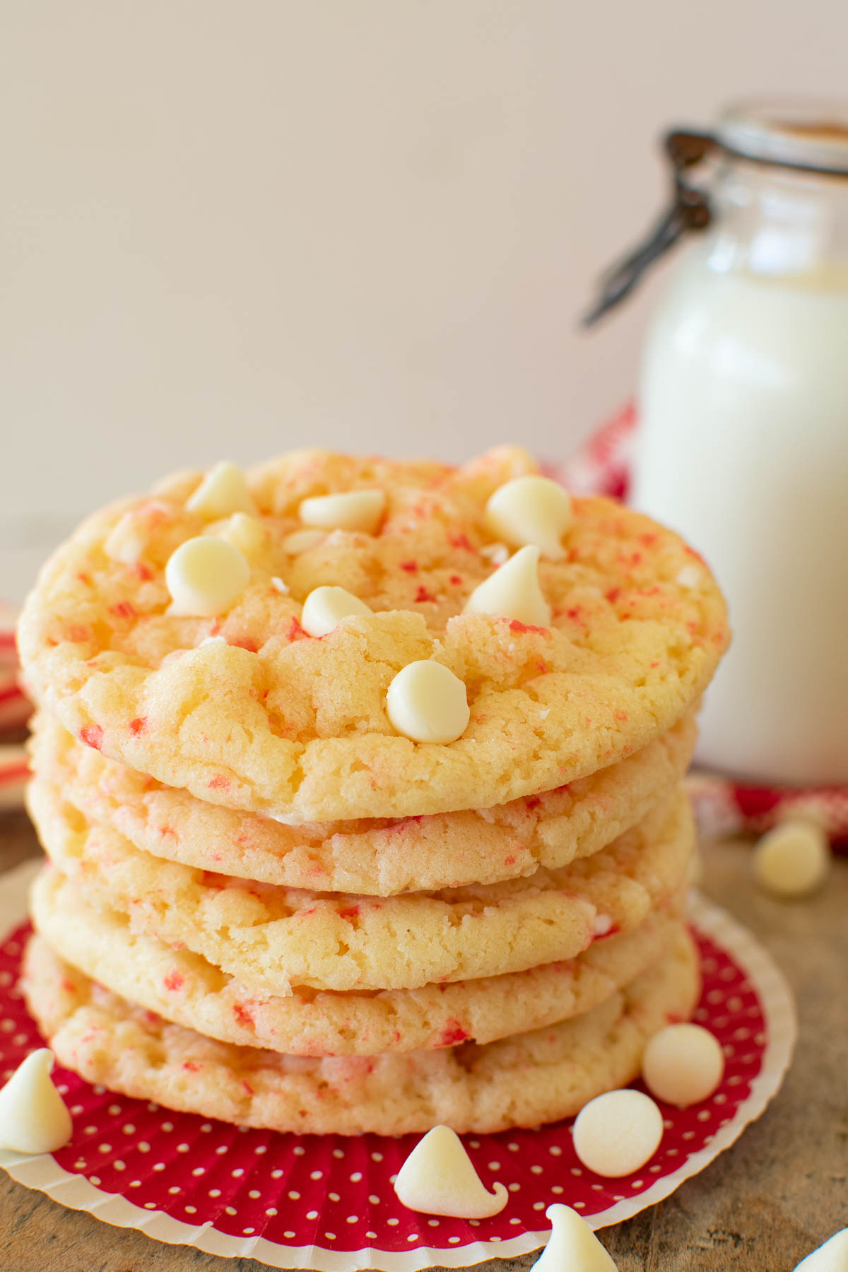 A stack of peppermint cookies with white chocolate chips and crushed candy canes.