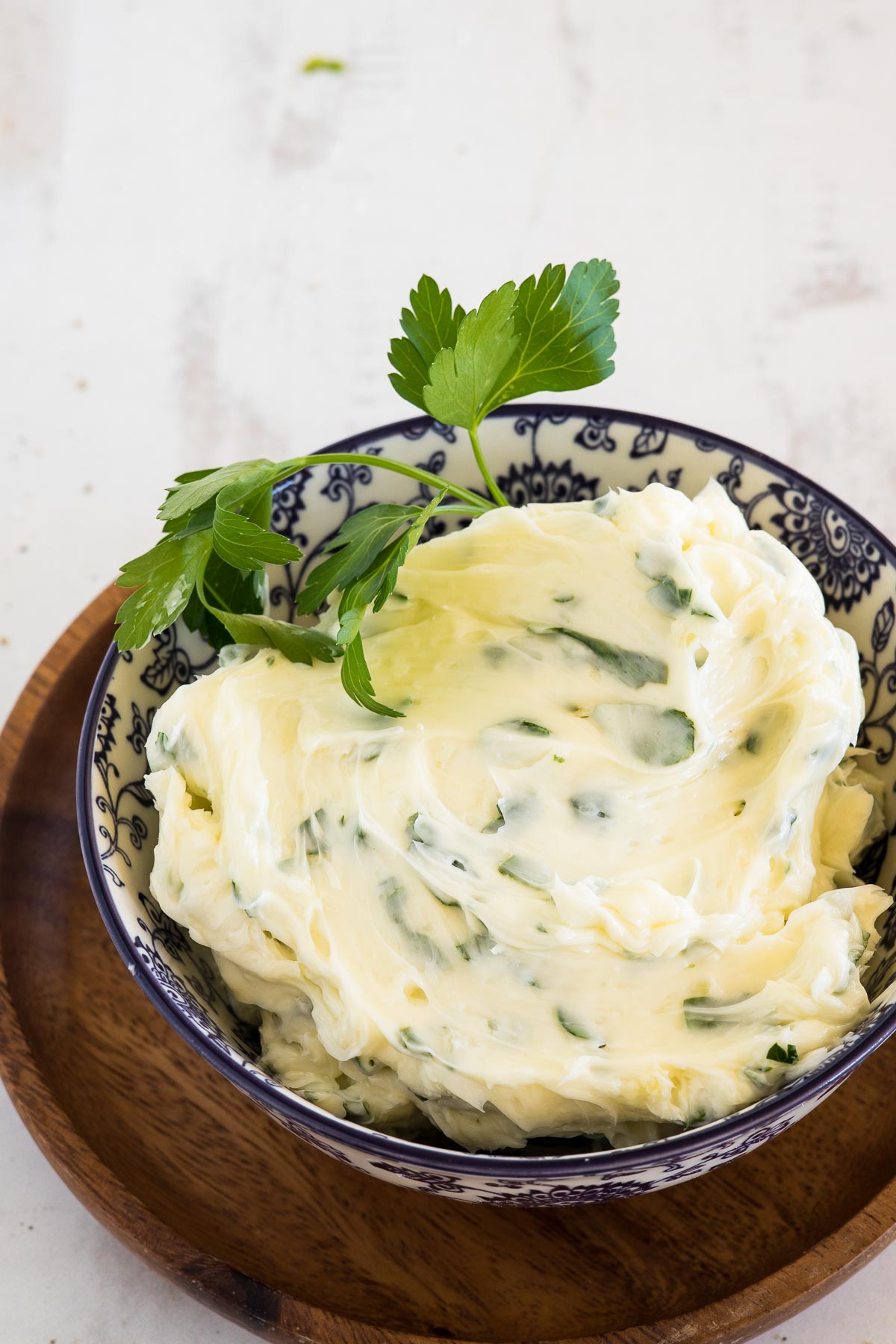 Butter with herbs and garlic in a bowl.