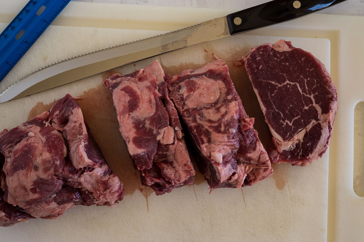 A beef tenderloin cut into filet mignon steaks.