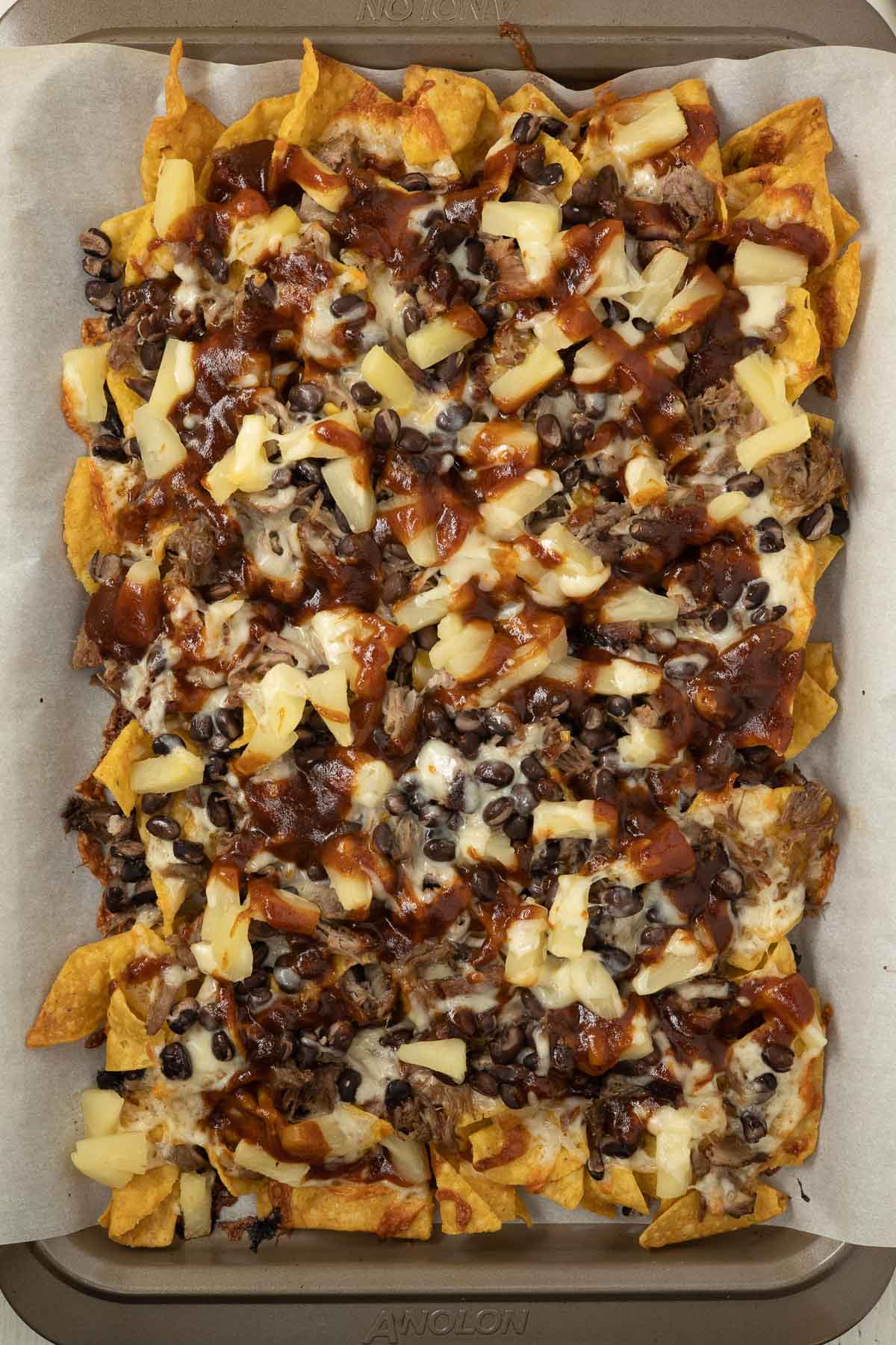 Baked nachos with barbecue sauce.