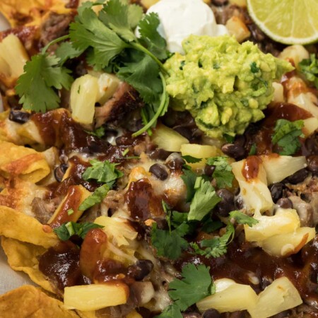 Baked nachos with tortilla chips and bbq pulled pork.