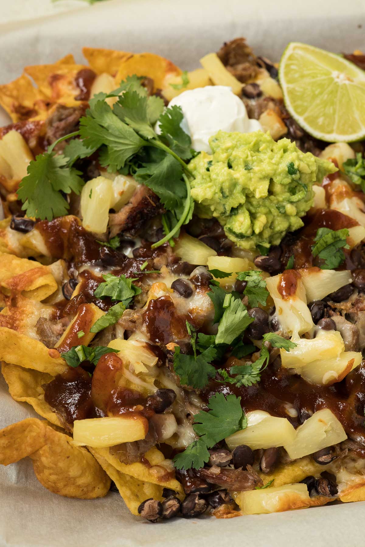 Baked nachos with tortilla chips and bbq pulled pork.