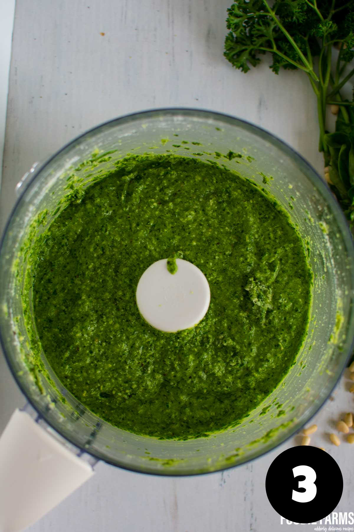 Blended pesto sauce in a food processor bowl.