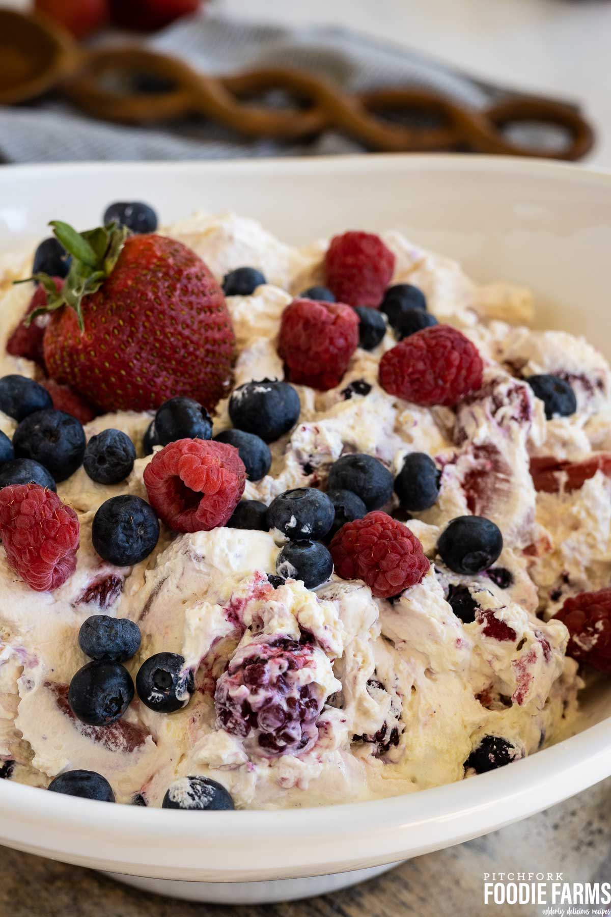 A creamy berry salad with fresh and frozen blueberries, raspberries, and strawberries.