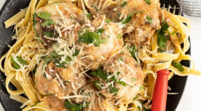 Meatballs made with beef and zucchini in a creamy tomato sauce serve over pasta.