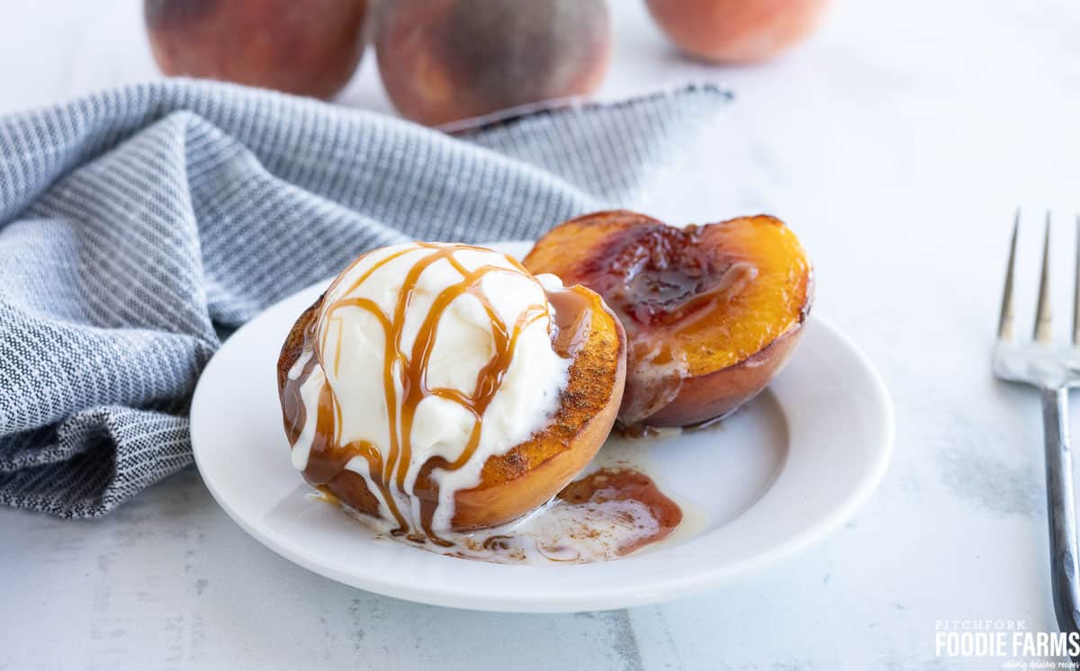 Peaches and ice cream drizzled with caramel sauce.