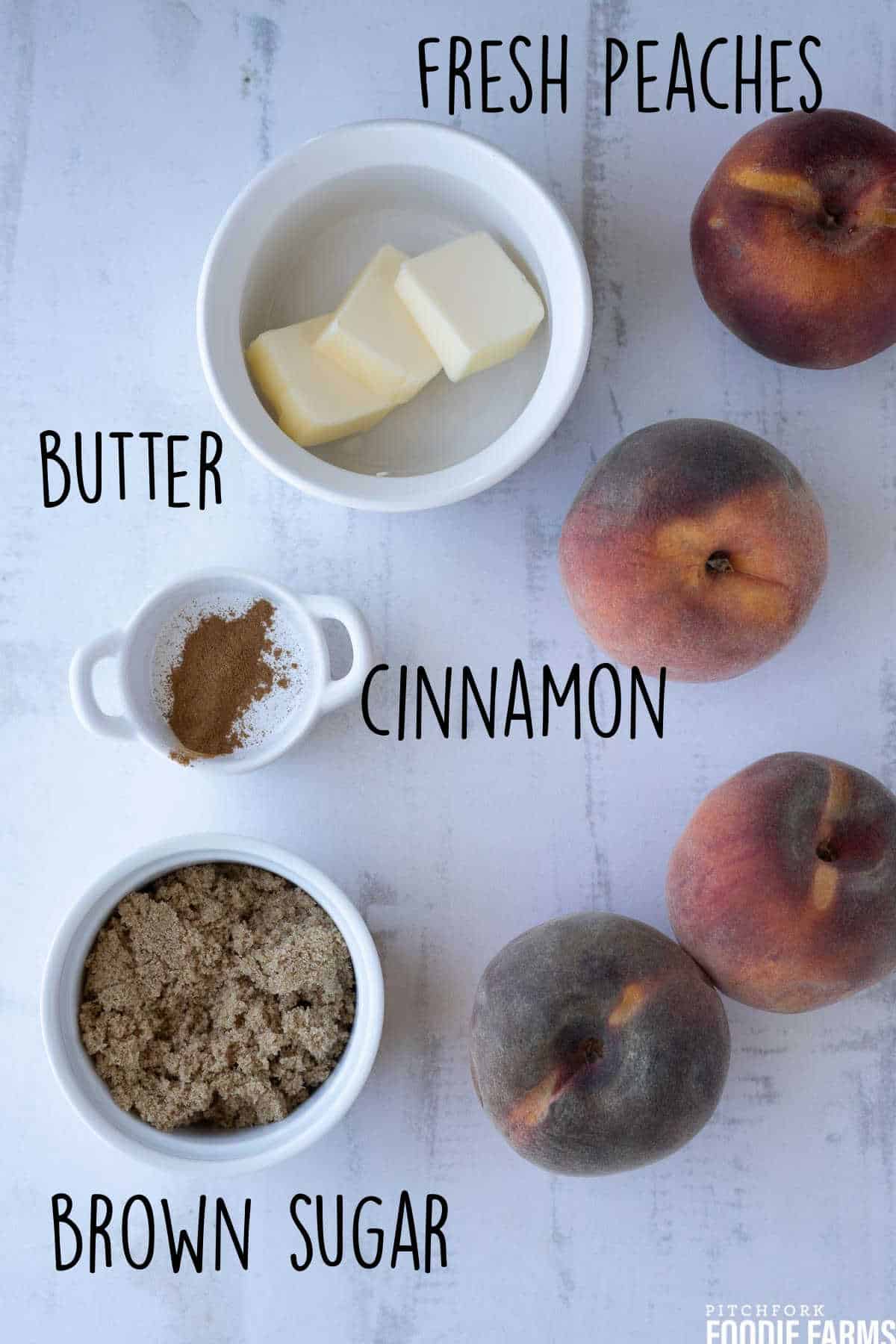 Butter, brown sugar, cinnamon, and fresh peaches showing the ingredients to make baked peaches.