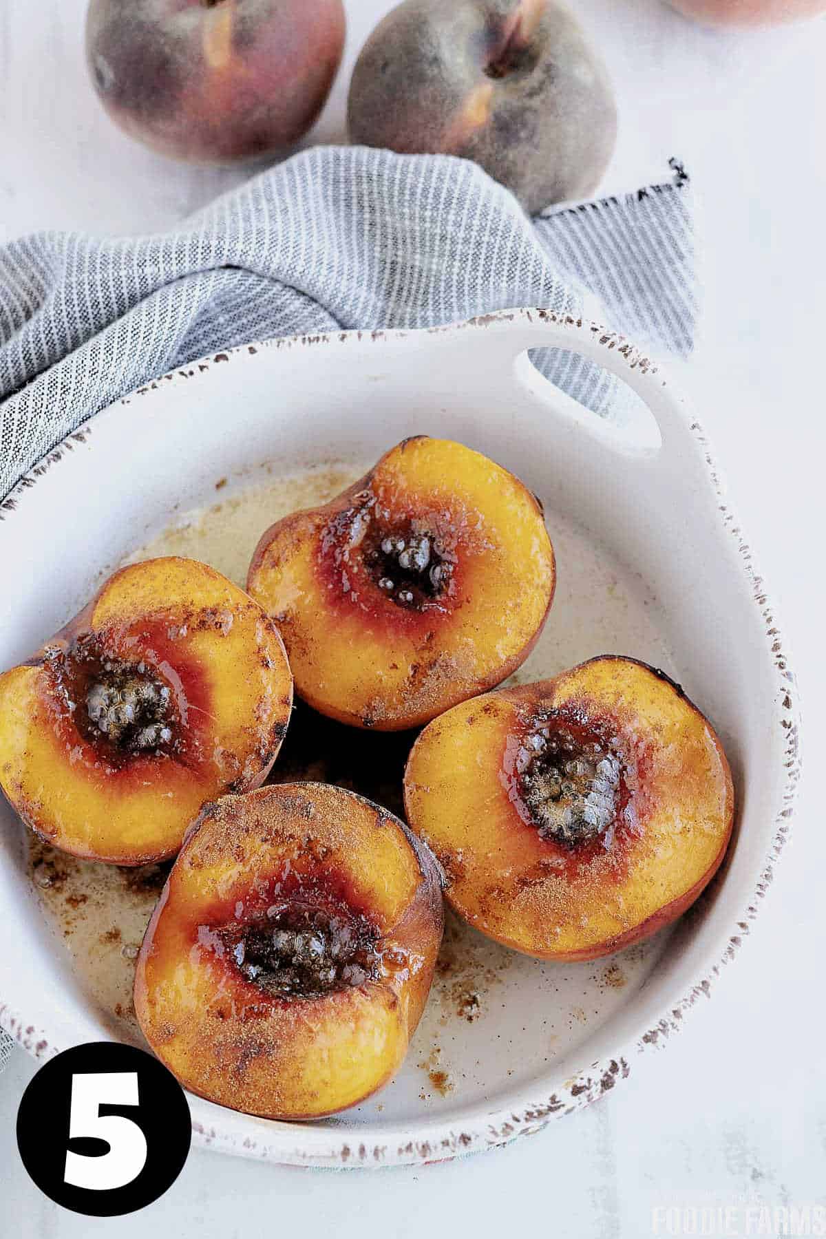 Roasted peaches with cooked butter and brown sugar on the top.