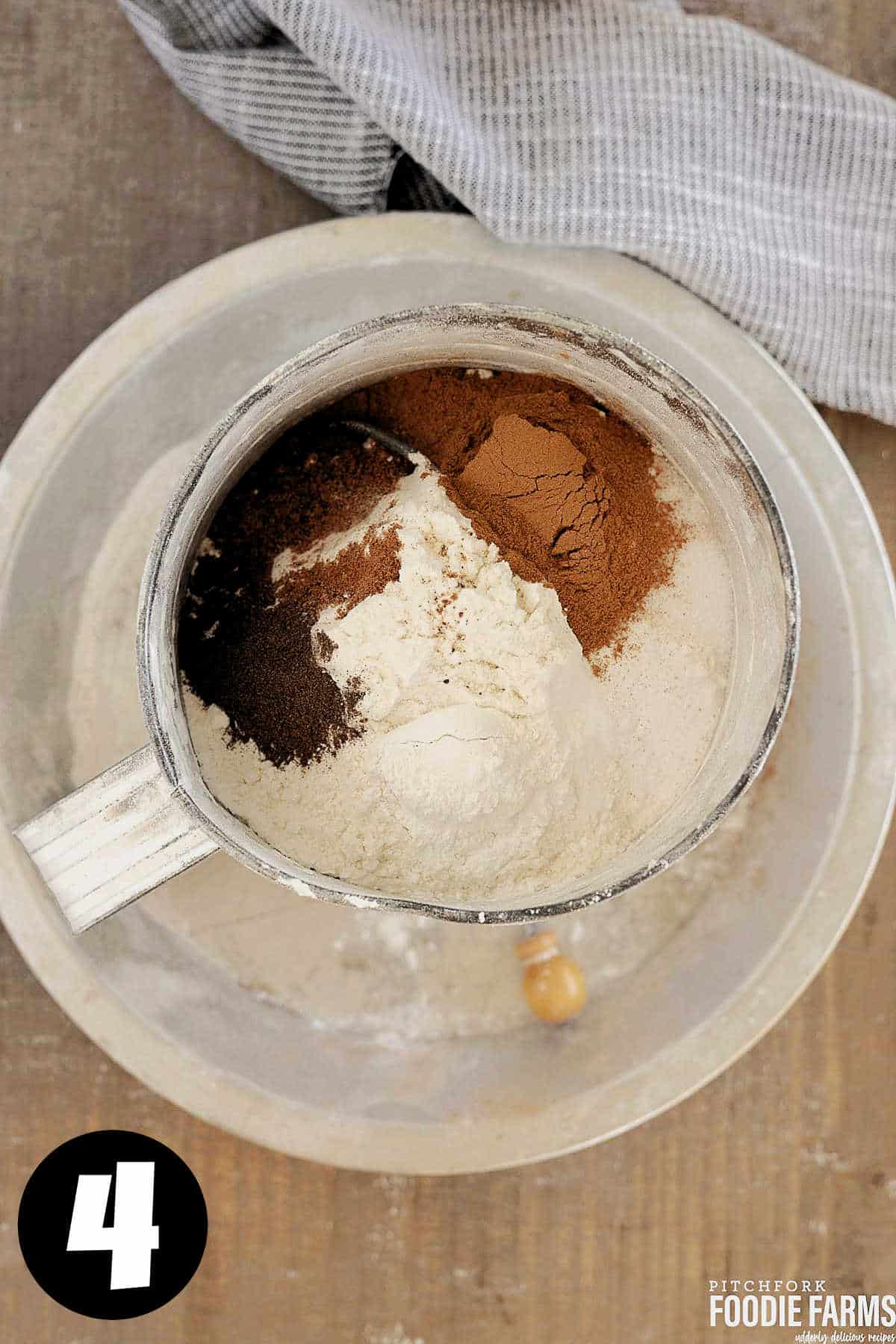 Flour, cinnamon, nutmeg, ginger, and cloves in a sifter.