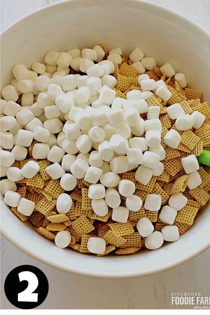 Marshmallows, Chex cereal, peanuts, and pretzels in a big bowl.