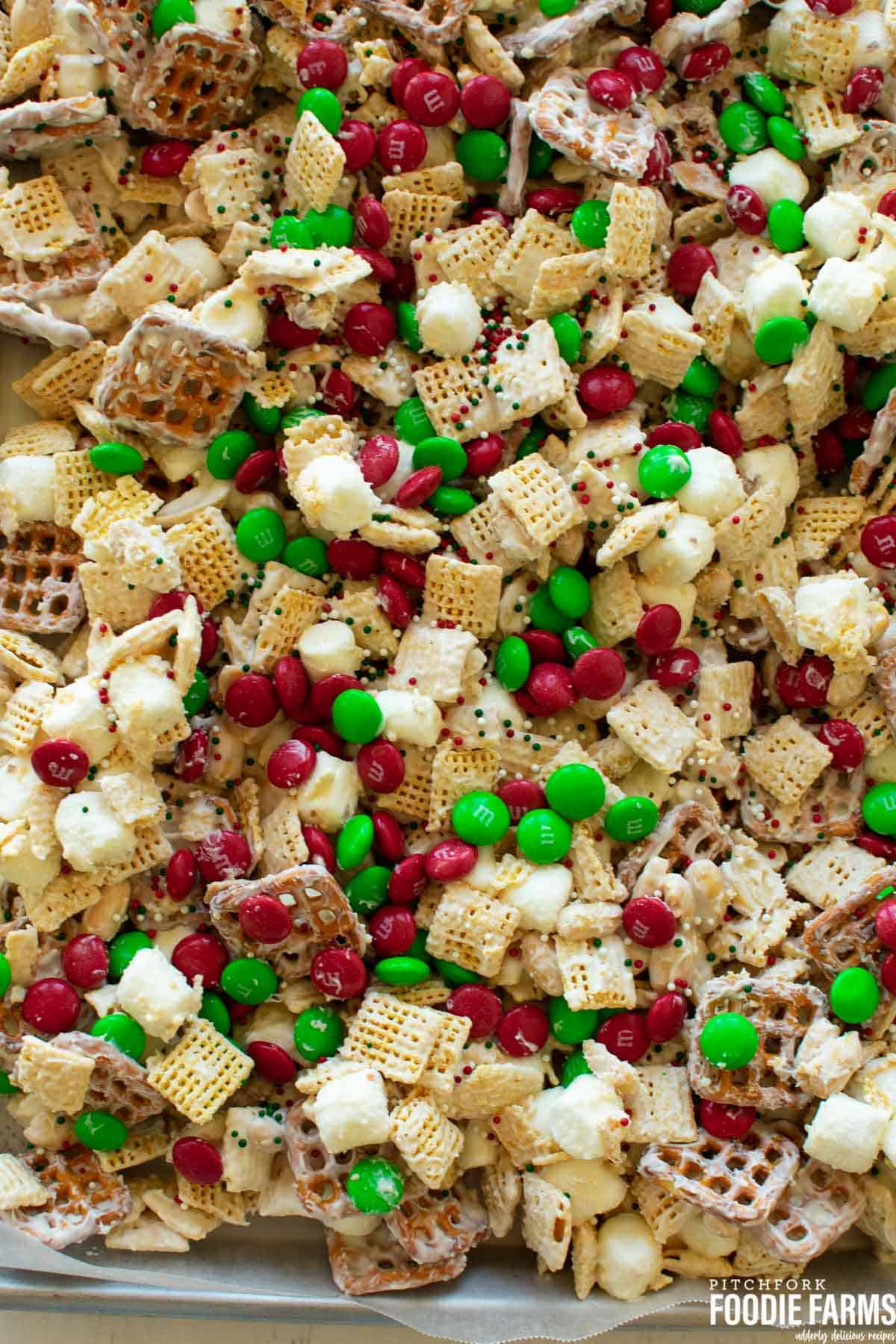 White chocolate covered Christmas Chex Mix on a baking sheet.