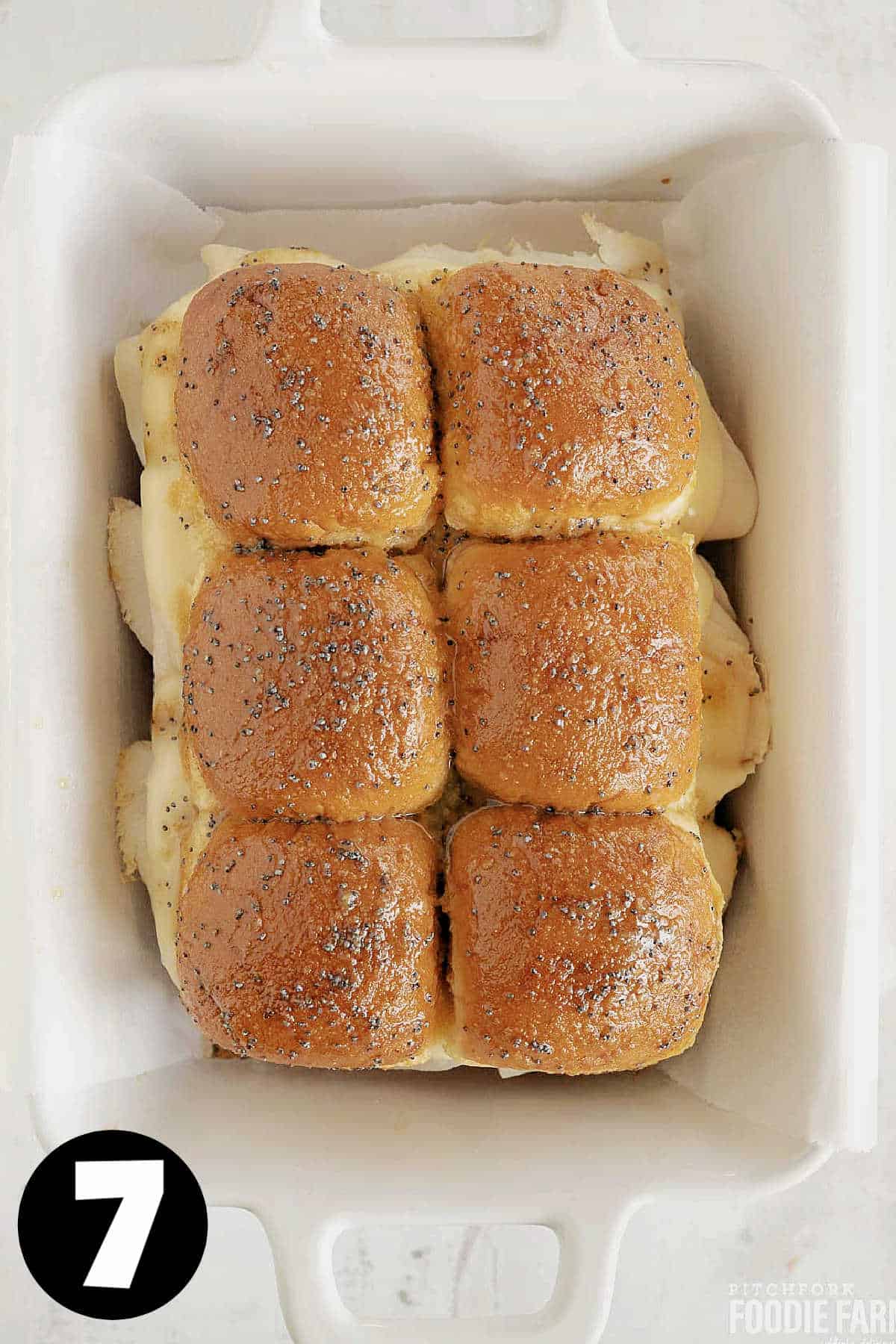 Baked sliders with poppy seed glaze on top.