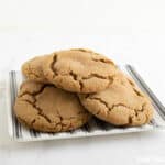 Gingersnap cookies on a black and white striped plate.