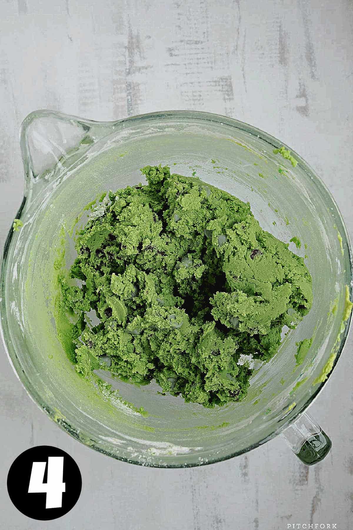 Green cookie dough with chocolate chips.