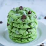A stack of green mint cookies with chocolate chips.