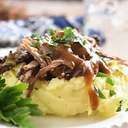 Shredded roast beef with gravy over mashed potatoes.