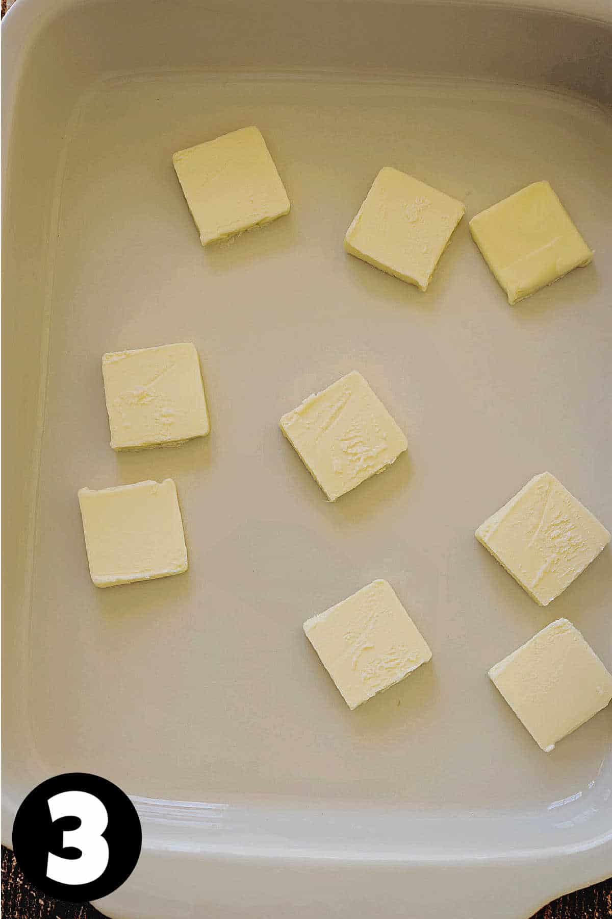 Slices of butter in a baking dish.