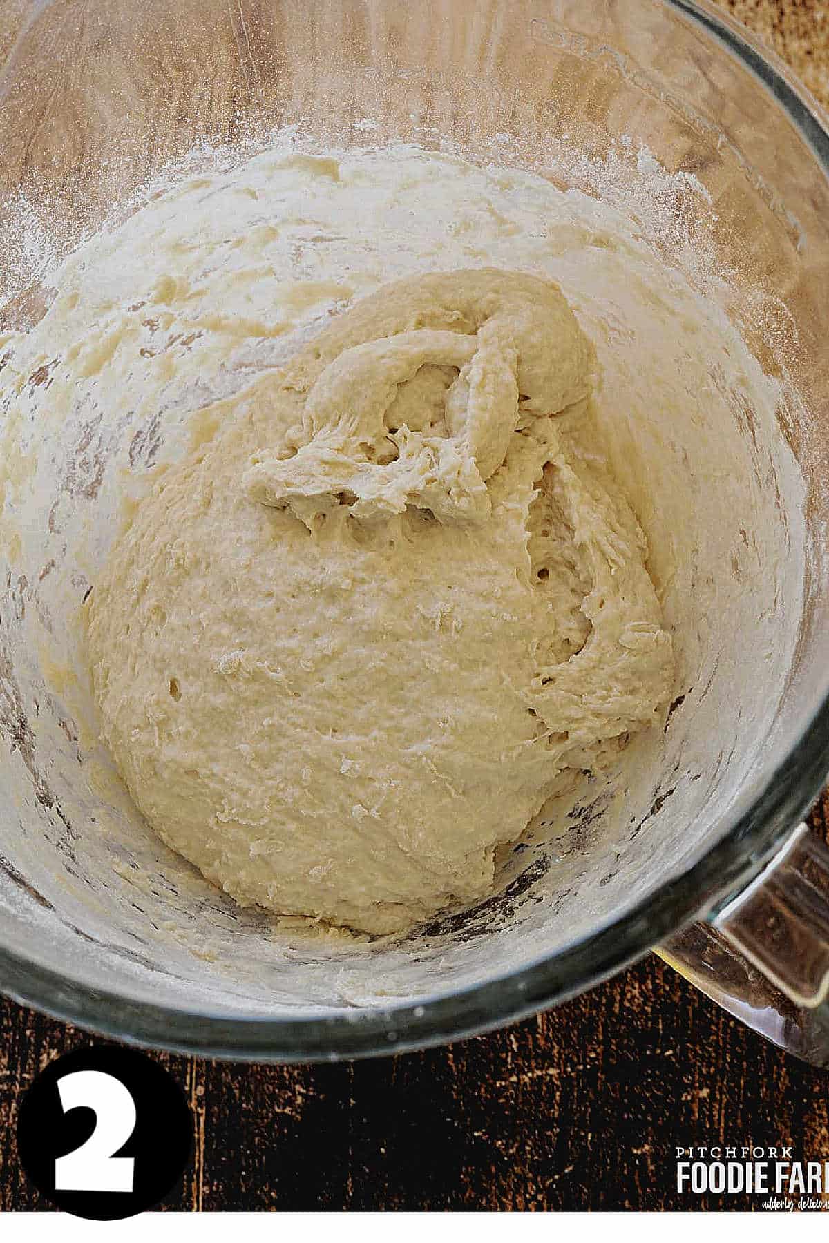 Homemade bread dough in a mixing bowl.