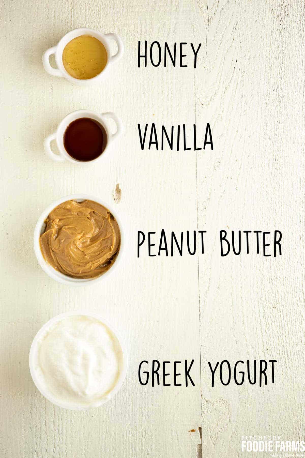 Peanut butter, honey, Greek yogurt and vanilla in containers.